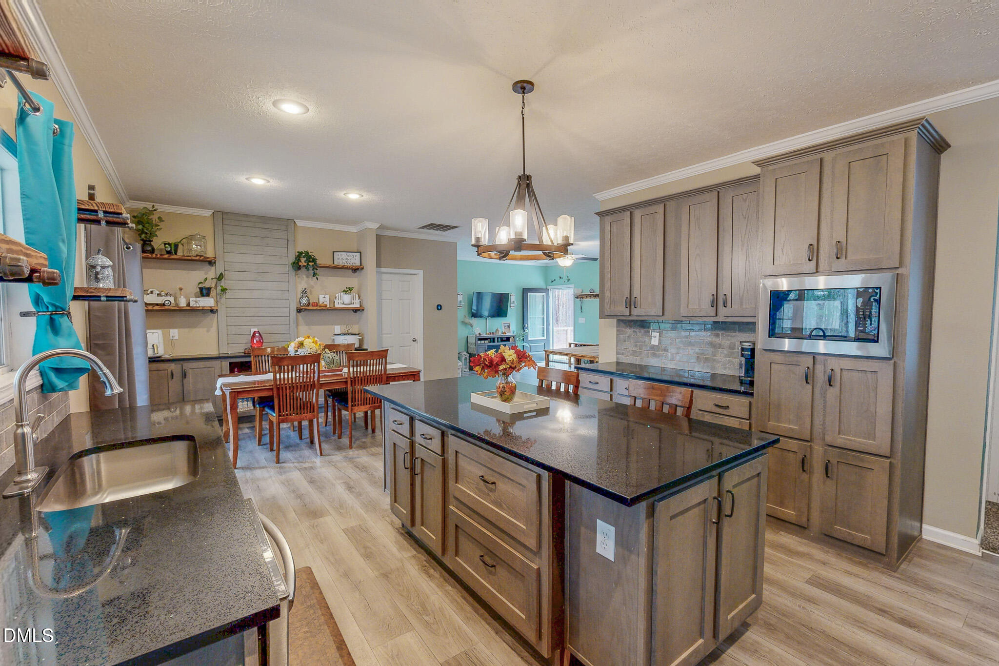 630 Clay Thomas Road Roxboro, NC 27573 - Photo 2 of 46 a kitchen that has a lot of cabinets a sink and appliances in it