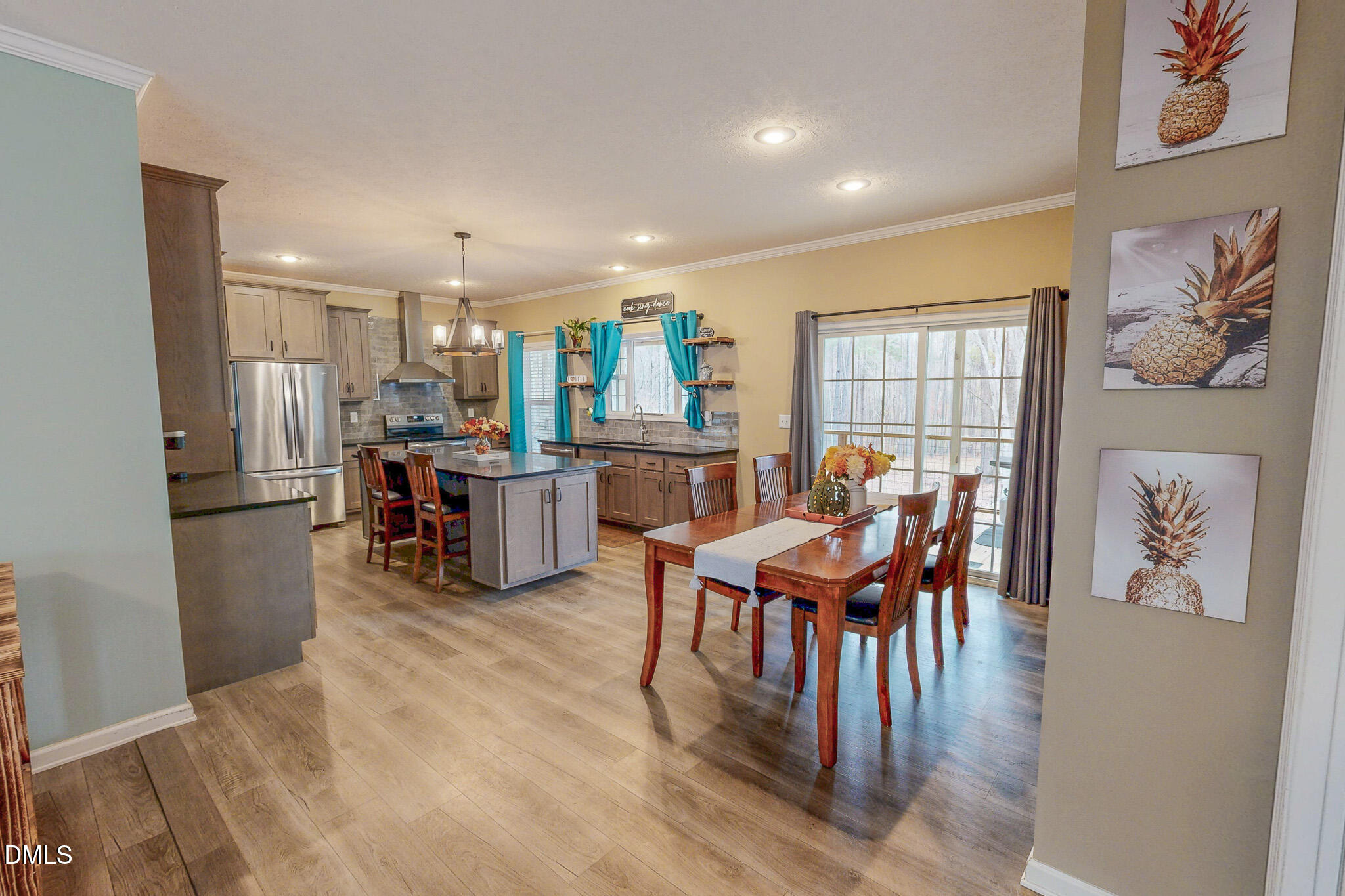 630 Clay Thomas Road Roxboro, NC 27573 - Photo 22 of 46 a living room with stainless steel appliances dining table furniture wooden floor and a kitchen view