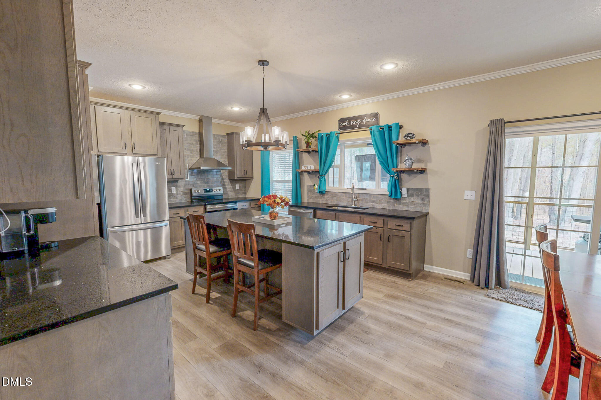 630 Clay Thomas Road Roxboro, NC 27573 - Photo 23 of 46 a kitchen with stainless steel appliances granite countertop a sink dishwasher a refrigerator and a dining table with wooden floor