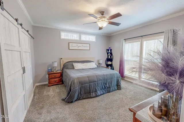 a spacious bedroom with a bed and a cabinets