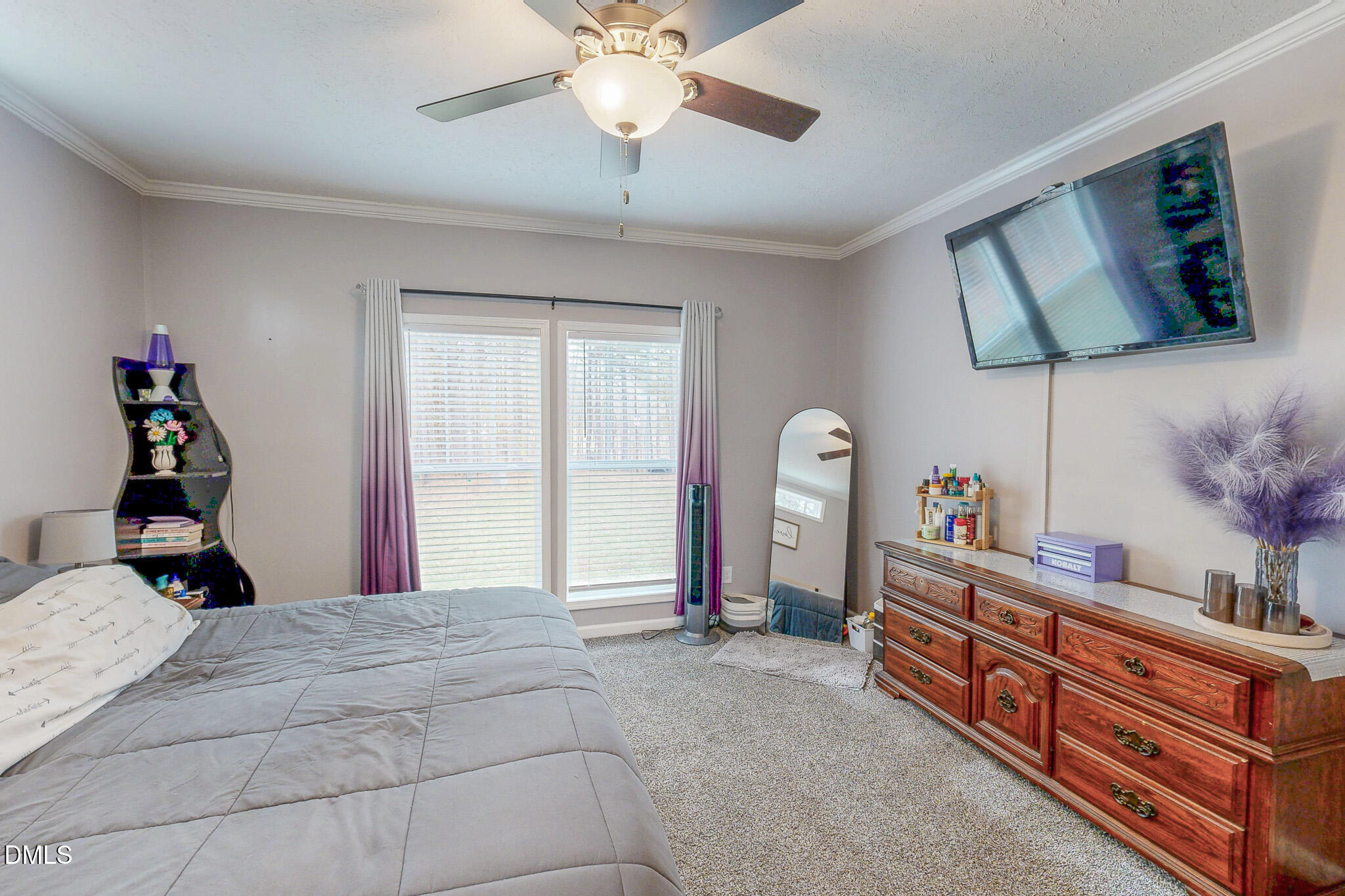 630 Clay Thomas Road Roxboro, NC 27573 - Photo 30 of 46 a bedroom with a bed and a chandelier