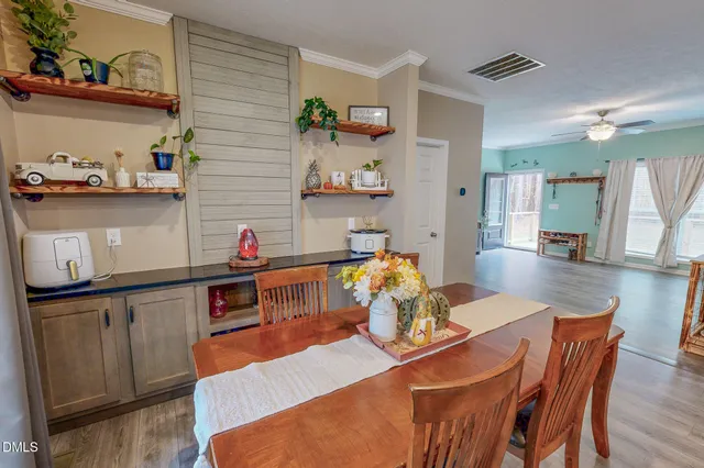 a view of a dining room with furniture and wooden floor