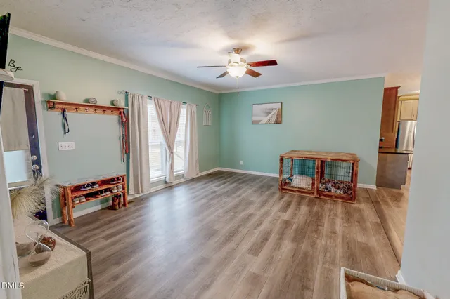 a view of a house with a yard and wooden fence