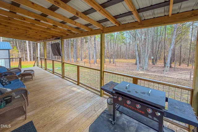 a view of sitting area with furniture and wooden deck