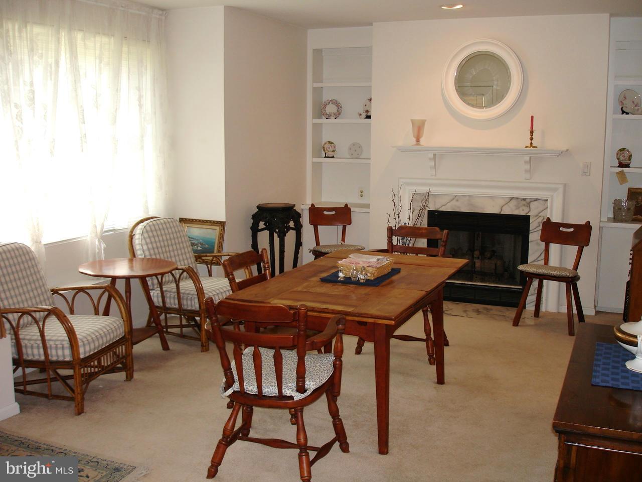 413 Rockfleet Road, Unit 101 Lutherville-Timonium, MD 21093 - Photo 8 of 27 DINING ROOM WITH BUILT-IN BOOKCASES AND GAS FP