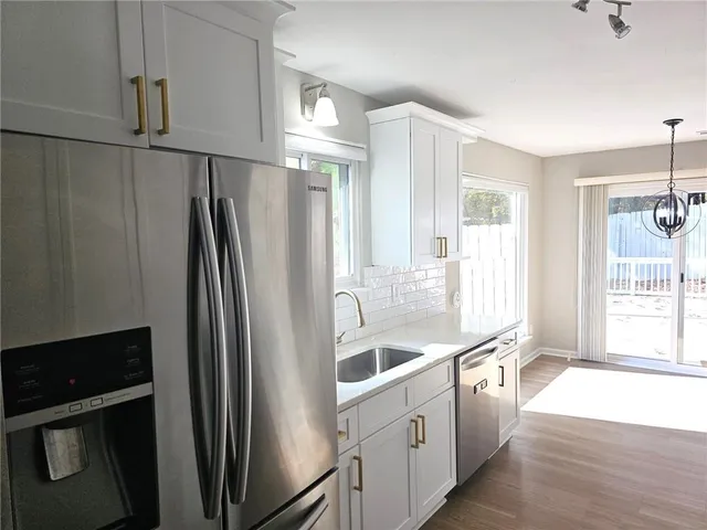 a kitchen with stainless steel appliances a refrigerator and a sink
