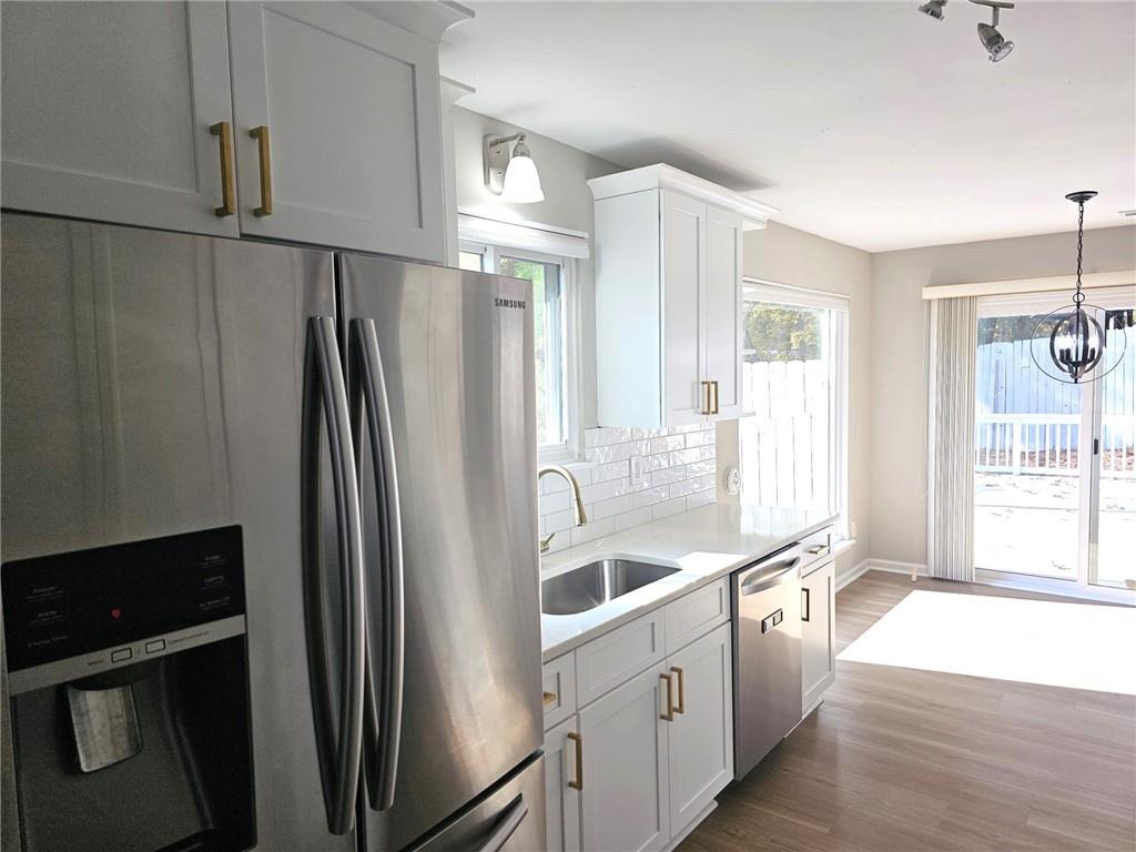 10085 Old Woodland Entry Johns Creek, GA 30022 - Photo 12 of 34 a kitchen with stainless steel appliances a refrigerator and a sink