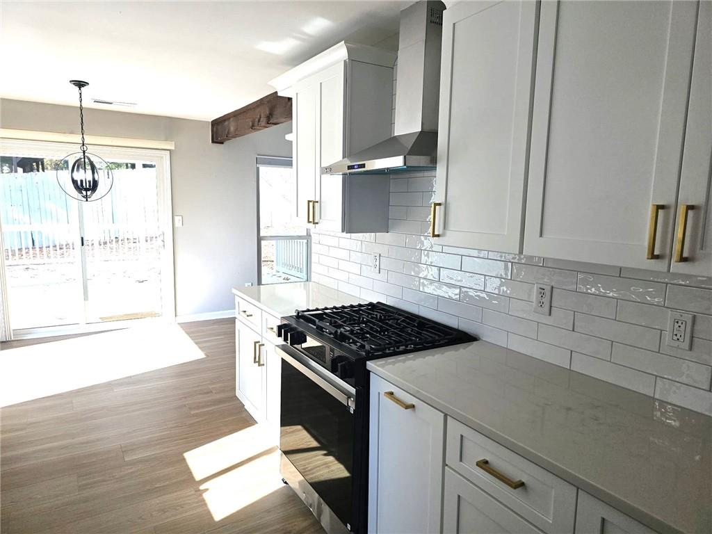 10085 Old Woodland Entry Johns Creek, GA 30022 - Photo 13 of 34 a kitchen with granite countertop a stove a sink and a refrigerator