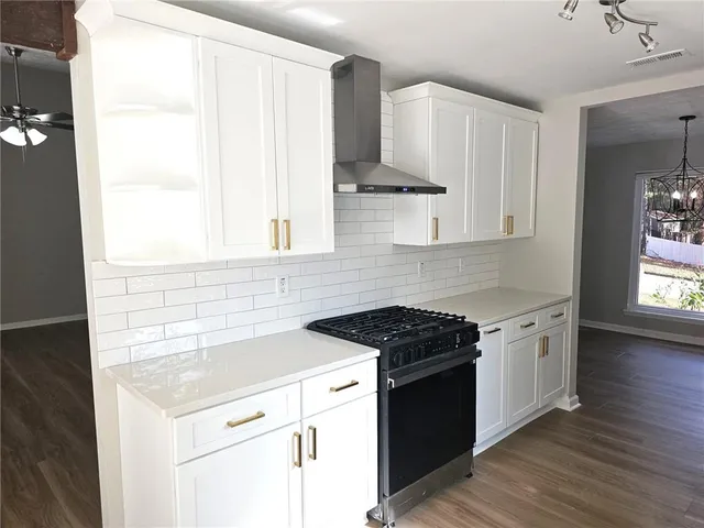a kitchen with a sink stove and cabinets