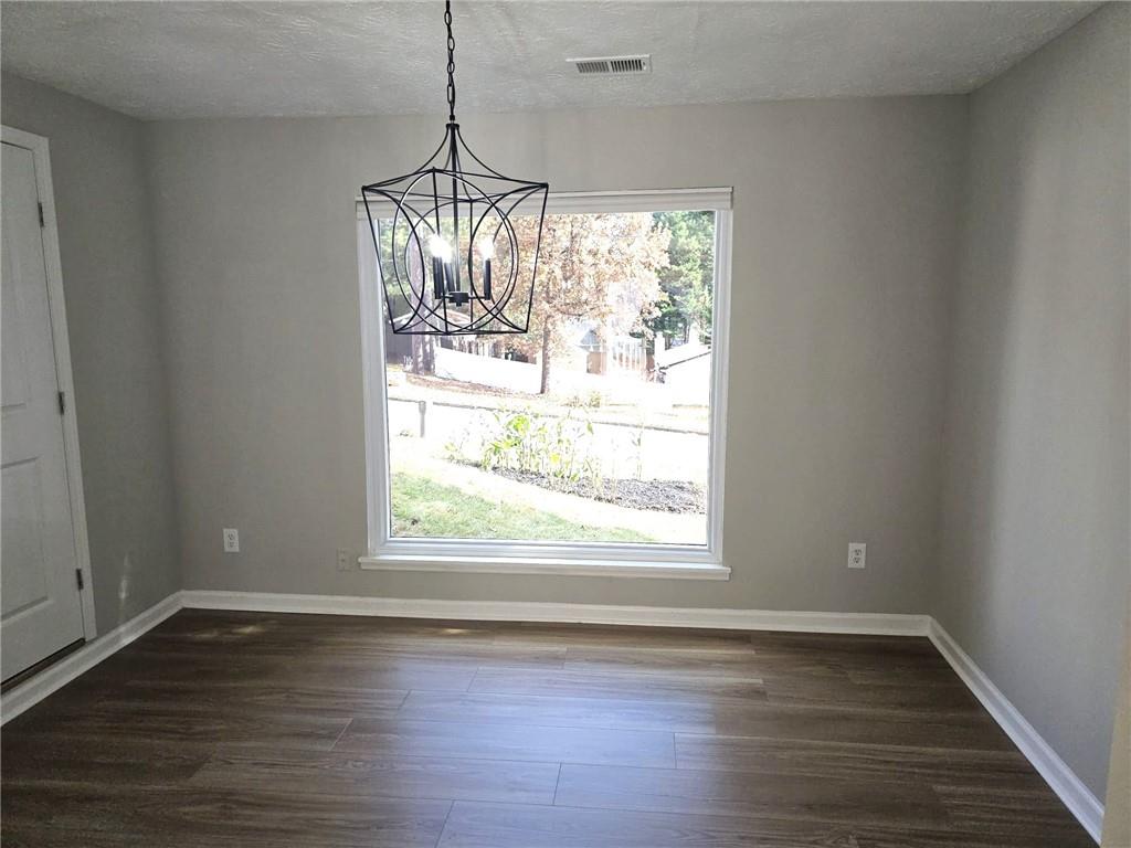 10085 Old Woodland Entry Johns Creek, GA 30022 - Photo 16 of 34 a view of empty room with wooden floor and fan