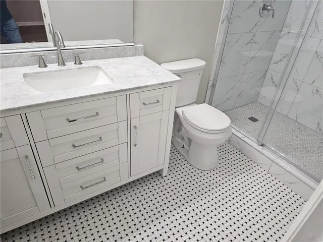 a bathroom with a sink a toilet and a mirror