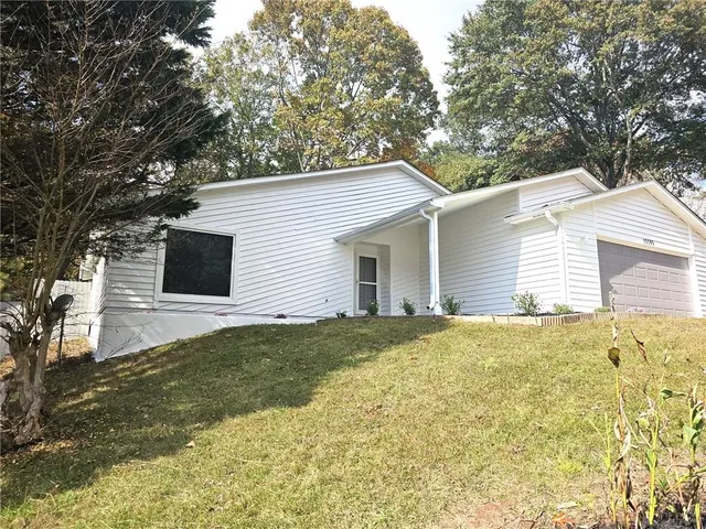 a view of a backyard with large trees