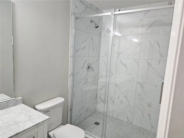 a bathroom with a shower and toilet