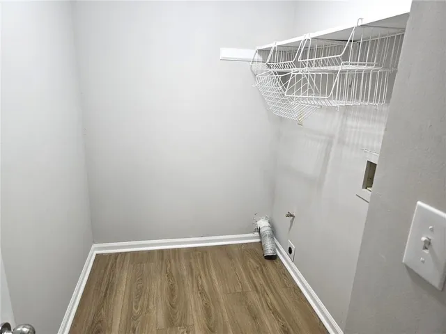 a view of storage and utility room with wooden floor