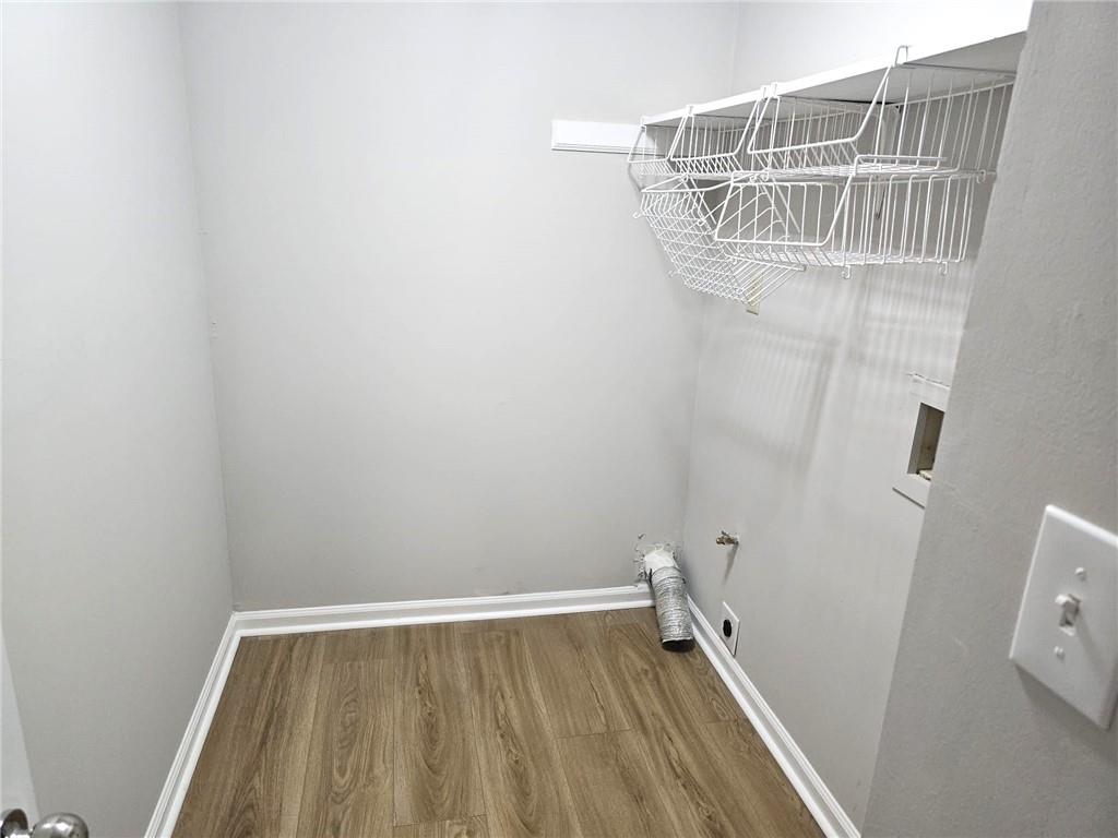 10085 Old Woodland Entry Johns Creek, GA 30022 - Photo 22 of 34 a view of storage and utility room with wooden floor