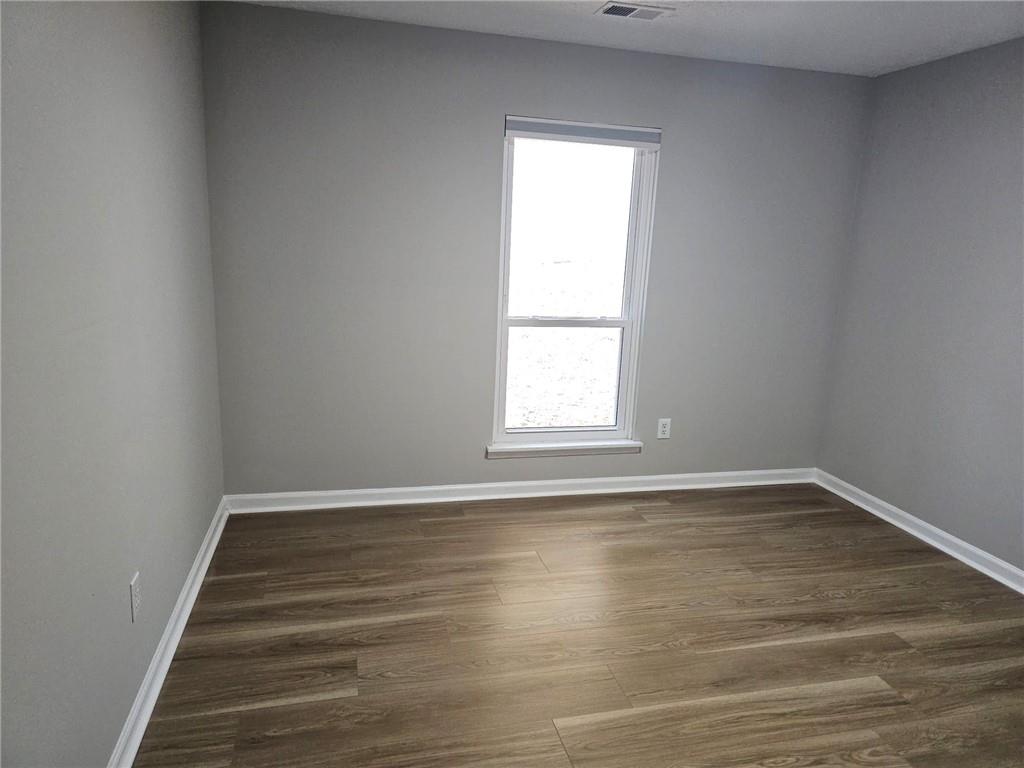 10085 Old Woodland Entry Johns Creek, GA 30022 - Photo 23 of 34 a view of an empty room with wooden floor and a window