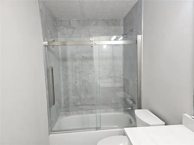a bathroom with a bathtub and shower