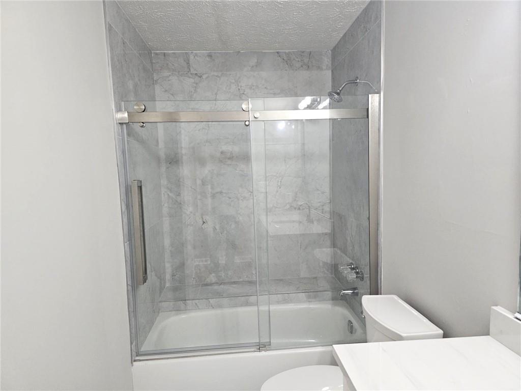 10085 Old Woodland Entry Johns Creek, GA 30022 - Photo 26 of 34 a bathroom with a bathtub and shower