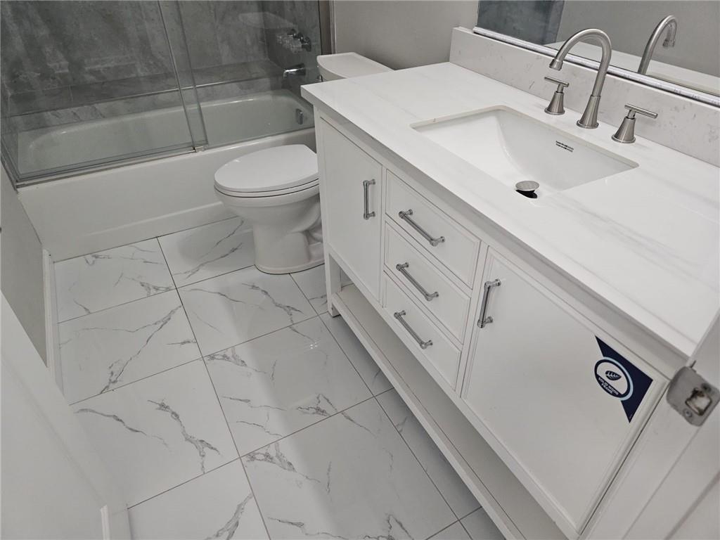 10085 Old Woodland Entry Johns Creek, GA 30022 - Photo 28 of 34 a bathroom with a sink toilet and shower
