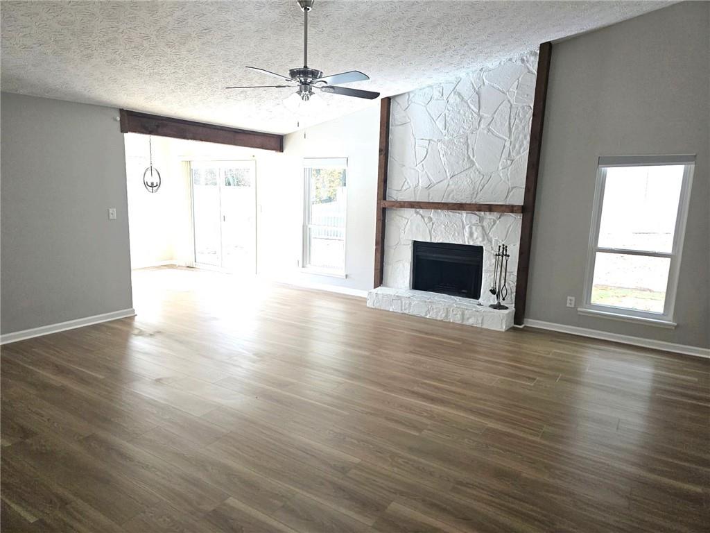 10085 Old Woodland Entry Johns Creek, GA 30022 - Photo 8 of 34 a view of an empty room with wooden floor fireplace and a window