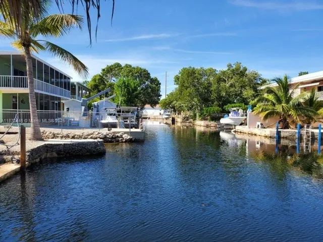 a view of swimming pool with outdoor seating and plants