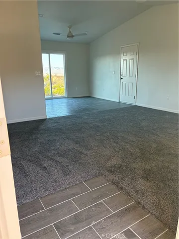 an empty room with a empty space and windows