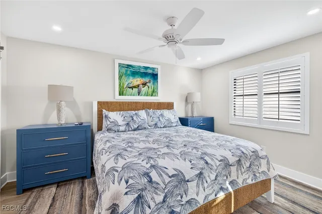 a spacious bedroom with a large bed couch and a window