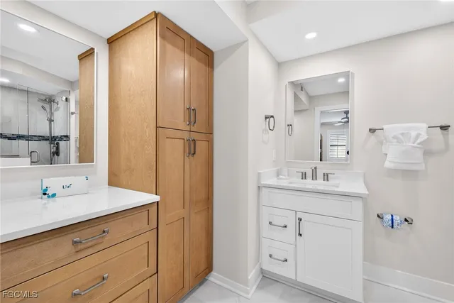 a spacious bathroom with a shower sink vanity mirror and toilet