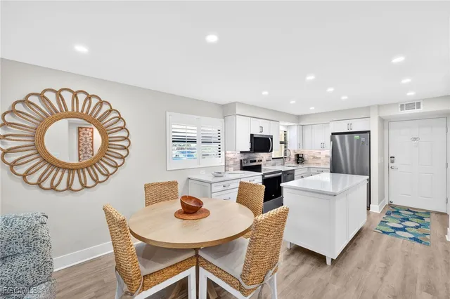 a kitchen with a refrigerator and cabinets