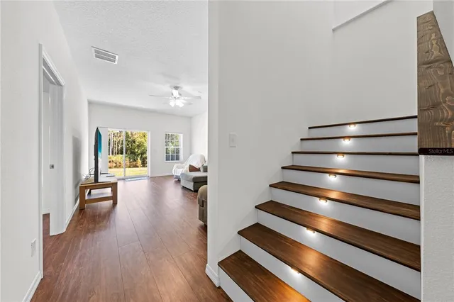 a kitchen with granite countertop cabinets stainless steel appliances and a window