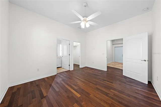 an empty room with windows and closet