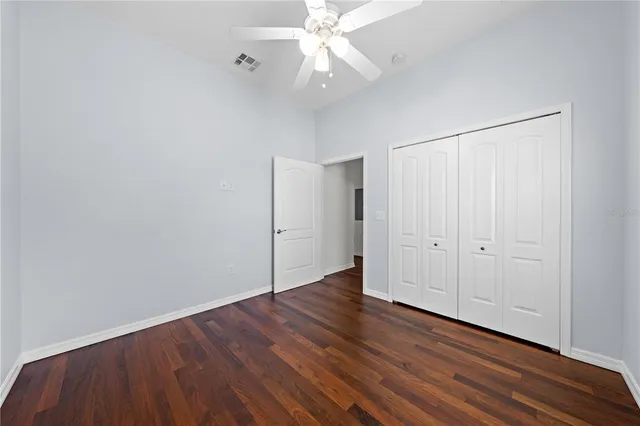 a bathroom with a granite countertop sink a toilet and a shower