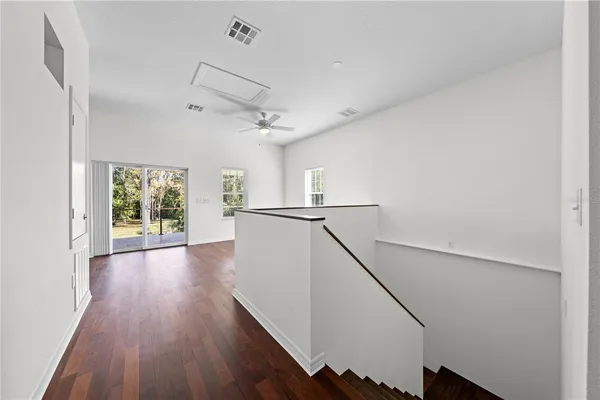a view of a a dining room with furniture a kitchen and chandelier