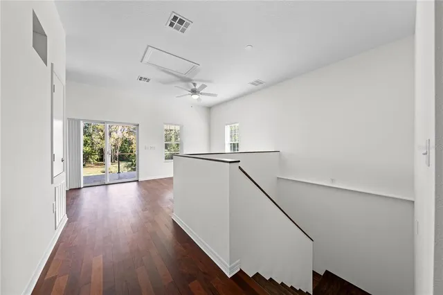 a view of a a dining room with furniture a kitchen and chandelier