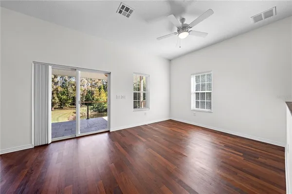 a open kitchen with a sink stove and wooden floor