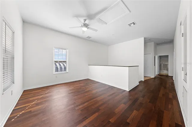 a kitchen with stainless steel appliances a dining table chairs microwave and sink