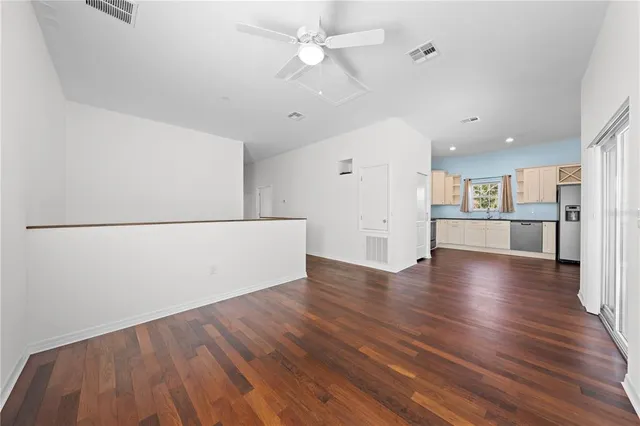 a kitchen with kitchen island wooden cabinets and stainless steel appliances