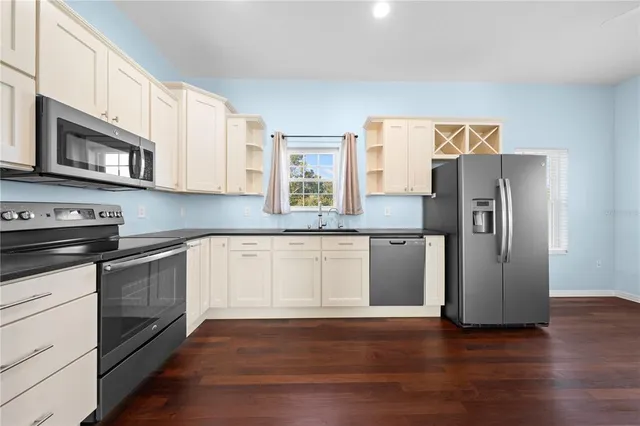 a bathroom with a sink a toilet a mirror and shower curtain