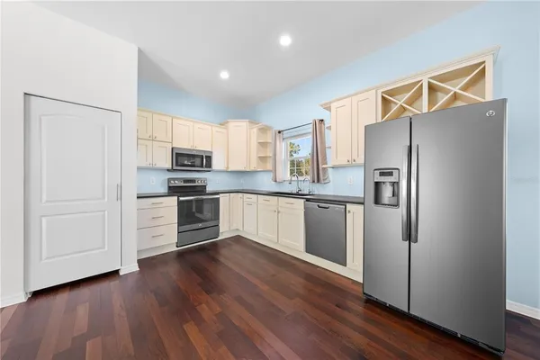 a front view of a house with a yard and trees