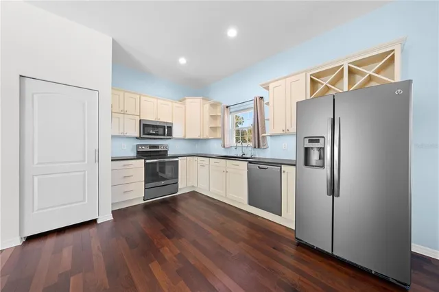 a front view of a house with a yard and trees