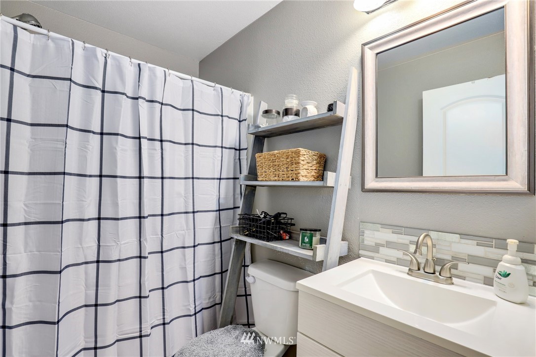 5433 66th Way Southeast Lacey, WA 98513 - Photo 11 of 20 a bathroom with a sink and a mirror