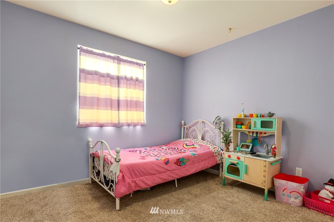 5433 66th Way Southeast Lacey, WA 98513 - Photo 12 of 20 a bedroom with a bed and a window