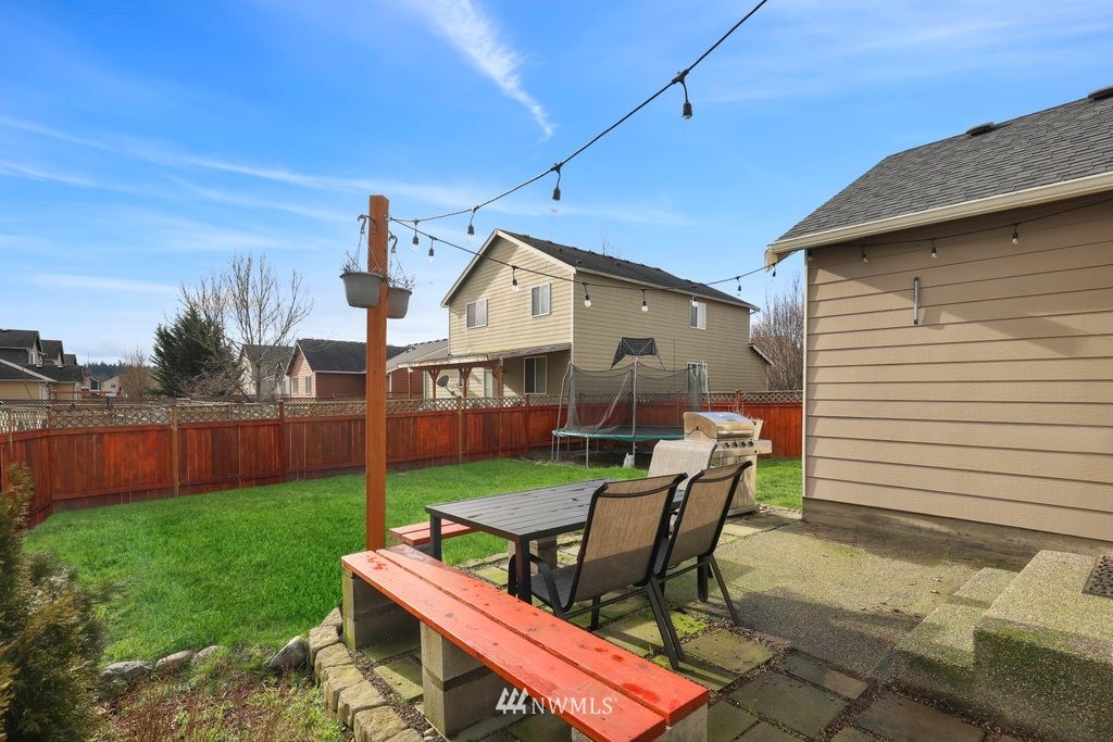 5433 66th Way Southeast Lacey, WA 98513 - Photo 16 of 20 a view of a chairs and table in backyard of the house