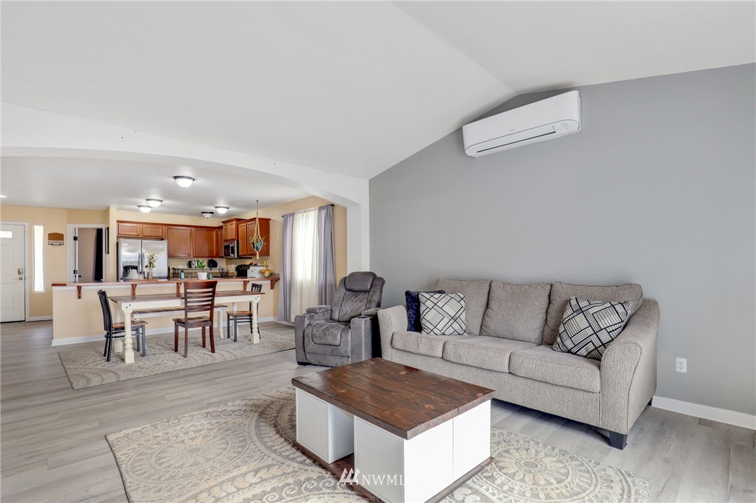 5433 66th Way Southeast Lacey, WA 98513 - Photo 6 of 20 a living room with furniture and a dining table with kitchen view