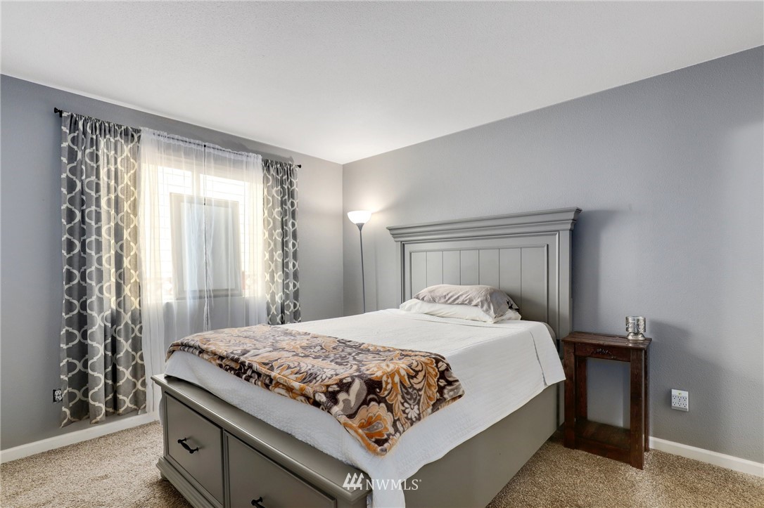 5433 66th Way Southeast Lacey, WA 98513 - Photo 9 of 20 a bedroom with a large bed and a dresser