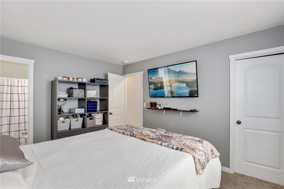 5433 66th Way Southeast Lacey, WA 98513 - Photo 10 of 20 a bedroom with a bed and a flat screen tv