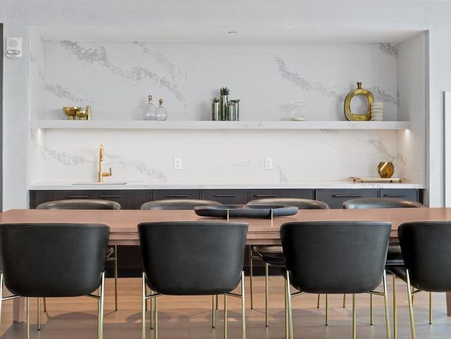 a kitchen with a table chairs and a sink