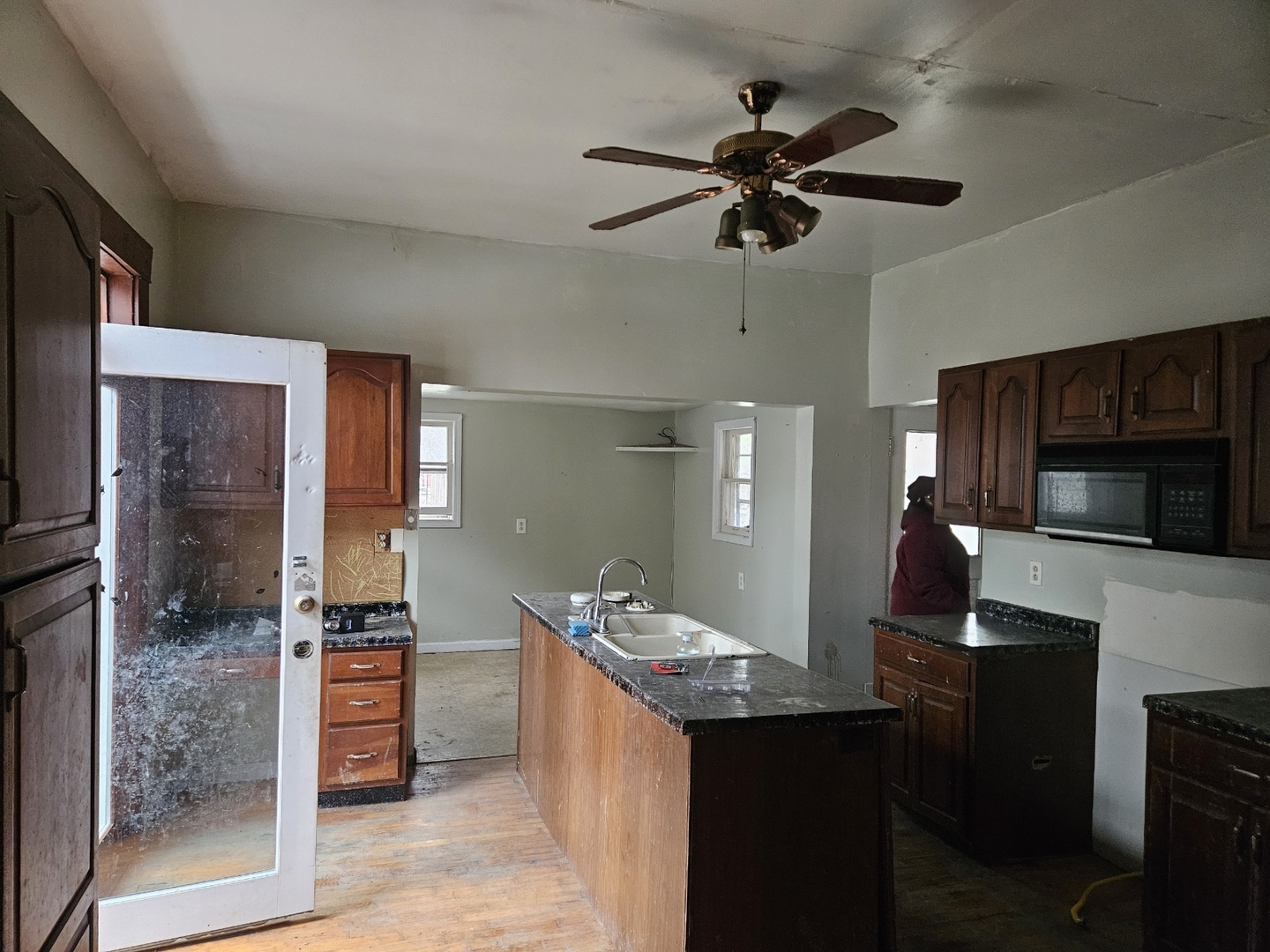 106 West Reynolds Street Newton, IL 62448 - Photo 8 of 12 a kitchen with a counter space a sink stainless steel appliances and cabinets
