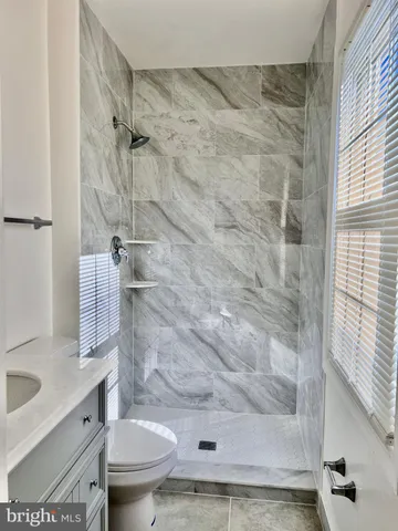a bathroom with a shower toilet and sink