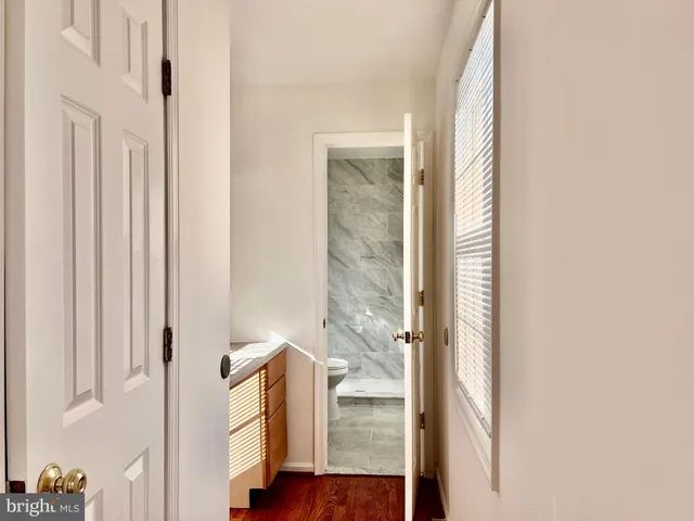 a view of hallway with wooden floor